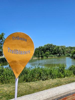 Tribune Trailblazers location sign in front of the pond.